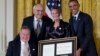 President Barack Obama, right, with former President George H. W. Bush, left, present the 5,000th Daily Point of Light Award to Floyd Hammer and Kathy Hamilton, center, from Union, Iowa, in the East Room of the White House in Washington, Jul. 15, 2013.