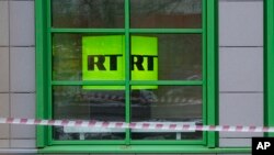 The logo of Russian state-owned television channel RT is seen on a window of the company's office in Moscow, Russia, Oct. 27, 2017.