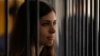 Member of the female punk band "Pussy Riot" Nadezhda Tolokonnikova looks out from a holding cell as she attends a court hearing to appeal for parole at the Supreme Court of Mordovia in Saransk, July 26, 2013. REUTERS/Sergei Karpukhin (RUSSIA - Tags: POLIT