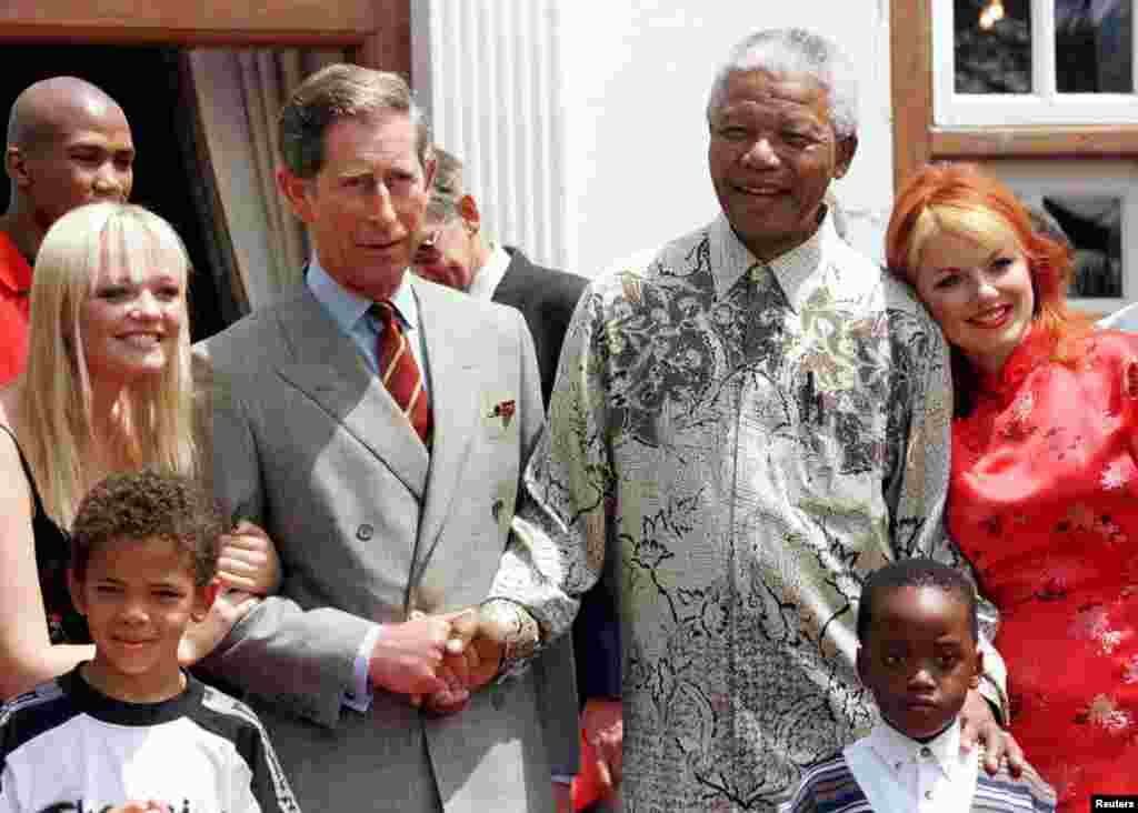 President Nelson Mandela and Britain&#39;s Prince Charles shake hands alongside members of the Spice Girls&#39; Emma (L), and Gerri (R) at Mr. Mandela&#39;s residence November 1, 1997.